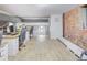 Open office area with multiple desks, hardwood floors, exposed brick, and modern lighting fixtures at 1732 Wazee St # 201, Denver, CO 80202