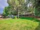 The backyard boasts mature landscaping, a lawn, and a storage shed at 4720 W Stanford Ave, Denver, CO 80236