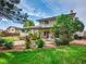 The backyard features mature landscaping, a patio, and a barbeque for entertainment at 4720 W Stanford Ave, Denver, CO 80236