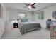 Bright bedroom with a ceiling fan, two windows, carpeted floors and ample storage at 4720 W Stanford Ave, Denver, CO 80236