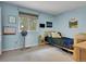 Light blue bedroom with a twin bed, window and carpeted floors at 4720 W Stanford Ave, Denver, CO 80236