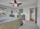 Comfortable bedroom with a ceiling fan, window and dresser at 4720 W Stanford Ave, Denver, CO 80236
