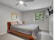 Neutral bedroom with a low platform bed, ceiling fan, TV and window with natural light at 4720 W Stanford Ave, Denver, CO 80236