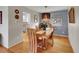 Elegant dining room featuring hardwood floors, a modern chandelier, and access to the kitchen at 4720 W Stanford Ave, Denver, CO 80236