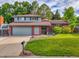 Charming two-story home with well-manicured lawn and attractive brick and siding at 4720 W Stanford Ave, Denver, CO 80236
