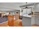 Open-concept kitchen features granite countertops, a breakfast bar, and seamless flow to the living room at 4720 W Stanford Ave, Denver, CO 80236