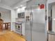 Spacious kitchen featuring stainless steel appliances and an adjoining dining area for gatherings at 4720 W Stanford Ave, Denver, CO 80236