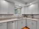 Well-lit kitchen with stainless steel appliances, ample cabinet space, and mosaic tile backsplash at 4720 W Stanford Ave, Denver, CO 80236