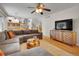 Bright living room with hardwood floors, comfy sectional seating, and modern media console at 4720 W Stanford Ave, Denver, CO 80236