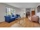Bright living room features a comfortable blue sofa, modern coffee table and a large window for ample natural light at 4720 W Stanford Ave, Denver, CO 80236