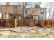 View of fenced backyard, showing patio doors and windows of the building at 2927 W 81St Ave # B, Westminster, CO 80031