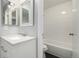 Bright bathroom with white vanity, quartz countertops, framed mirrors, and a shower-tub combination at 2927 W 81St Ave # B, Westminster, CO 80031