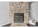 Detailed stone fireplace is the focal point of the living area at 2927 W 81St Ave # B, Westminster, CO 80031