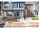 Charming townhome showcasing a stone foundation, blue and tan siding, and a well-maintained brick sidewalk at 2927 W 81St Ave # B, Westminster, CO 80031