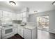 Well-equipped kitchen with white cabinets, mosaic backsplash, and stainless steel appliances at 2927 W 81St Ave # B, Westminster, CO 80031