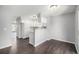 Open-concept kitchen featuring white cabinets, quartz countertops, stainless steel appliances, and wood flooring at 2927 W 81St Ave # B, Westminster, CO 80031