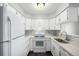 Bright kitchen features white cabinets, updated countertops, and stainless steel appliances at 2927 W 81St Ave # B, Westminster, CO 80031