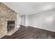 Inviting living room featuring a stone fireplace and modern dark wood flooring at 2927 W 81St Ave # B, Westminster, CO 80031
