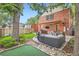 Spacious backyard featuring a mini golf area, stone patio, and a built-in outdoor kitchen at 2436 W Argyle Pl, Denver, CO 80211