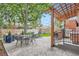 Spacious backyard with stone patio, outdoor furniture, a lush lawn, and a charming pergola at 2436 W Argyle Pl, Denver, CO 80211