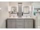 Modern bath featuring double vanity, decorative tile backsplash, and a frameless glass shower enclosure at 2436 W Argyle Pl, Denver, CO 80211