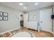 A bright Bedroom is freshly painted and includes hardwood floors and a fun letter rug at 2436 W Argyle Pl, Denver, CO 80211