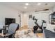 Bright home office with a Peloton bike, television, and ample natural light, ideal for working out at home at 2436 W Argyle Pl, Denver, CO 80211