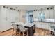 Elegant kitchen featuring white cabinetry, a center island, stainless steel appliances, and hardwood flooring at 2436 W Argyle Pl, Denver, CO 80211