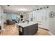 Bright, open living space featuring a modern kitchen, a cozy living area, and hardwood floors at 2436 W Argyle Pl, Denver, CO 80211