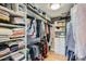 A large walk-in closet has ample shelving and hanging storage for clothes, shoes and accessories at 2436 W Argyle Pl, Denver, CO 80211