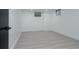 Clean, bright basement room features modern gray wood flooring and freshly painted white walls at 8249 Zephyr St, Arvada, CO 80005