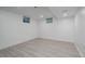 Spacious basement room with new light-colored floors, bright white walls, and recessed lighting at 8249 Zephyr St, Arvada, CO 80005