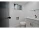 Clean bathroom featuring a modern vanity, toilet, and window at 8249 Zephyr St, Arvada, CO 80005