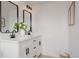 Bathroom featuring dual sinks, modern fixtures, and clean white cabinetry at 8249 Zephyr St, Arvada, CO 80005
