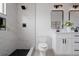 Modern bathroom features a glass-enclosed shower with black fixtures and dual vanity at 8249 Zephyr St, Arvada, CO 80005