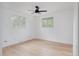 Bright bedroom with hardwood floors, ceiling fan, and multiple windows at 8249 Zephyr St, Arvada, CO 80005