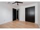 Bright bedroom featuring hardwood floors, a ceiling fan and an adjacent bathroom at 8249 Zephyr St, Arvada, CO 80005