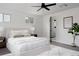 Bright bedroom features a plush bed, neutral decor, and en-suite bathroom for ultimate relaxation at 8249 Zephyr St, Arvada, CO 80005
