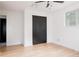 Bright bedroom featuring closet and hardwood floors at 8249 Zephyr St, Arvada, CO 80005