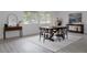 Dining room with a wooden table, seating for six, and a modern mirror on the wall at 8249 Zephyr St, Arvada, CO 80005