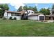 Charming home with well-manicured lawn and complementary white and dark trim at 8249 Zephyr St, Arvada, CO 80005