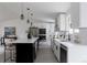 Modern kitchen with a large island, white cabinets, and stainless steel appliances at 8249 Zephyr St, Arvada, CO 80005