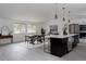 Open-concept kitchen and dining area with modern fixtures and lots of natural light at 8249 Zephyr St, Arvada, CO 80005