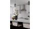 Modern kitchen featuring a large island with seating and a stainless steel range hood at 8249 Zephyr St, Arvada, CO 80005