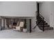 Upstairs area with modern railings, a chair with a throw blanket, and a view into another room at 8249 Zephyr St, Arvada, CO 80005