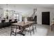 Open concept living area with a dining table, kitchen in the background, and stairs leading to the second floor at 8249 Zephyr St, Arvada, CO 80005