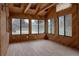 Bright sunroom with wood-paneled walls, tiled floors, and windows offering serene views and abundant natural light at 8249 Zephyr St, Arvada, CO 80005
