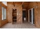 Unique sunroom with wood-paneled walls, tiled floors, staircase, offering a rustic retreat with natural light at 8249 Zephyr St, Arvada, CO 80005