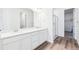 Sleek bathroom with double sinks, a glass-enclosed shower, and modern fixtures at 9112 Telluride Ct, Commerce City, CO 80022