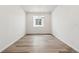 Bedroom with neutral wood flooring, one window, and white walls at 9112 Telluride Ct, Commerce City, CO 80022